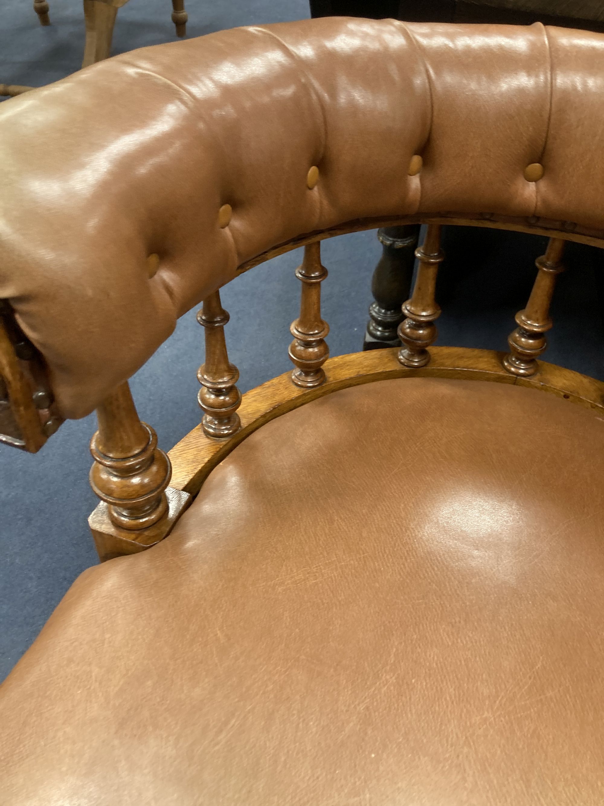 A Victorian oak tub framed library chair, upholstered in brown leather, width 60cm, depth 60cm, height 74cm